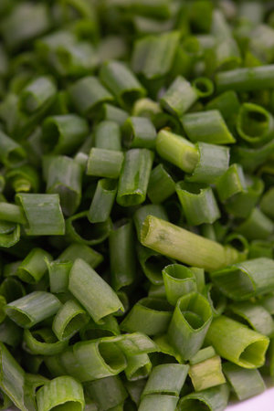 chopped green onions in a bowl, close-up, verticalの写真素材