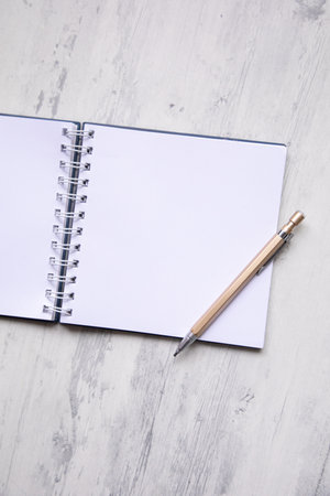 Blank notebook with pen on wooden table. Top view with copy spaceの写真素材