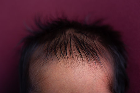 Newborn baby's hair on a purple background. Close-up.の写真素材