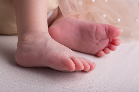 Newborn baby feet on a white background, close-up.の写真素材