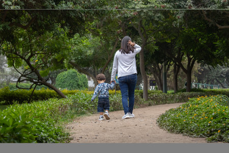 Mother and son walking in the park. The concept of family life.の写真素材