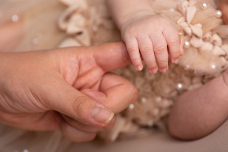 Newborn baby holding mother's hand. Close-up shot.の写真素材