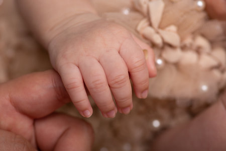 Newborn baby's hand in mother's hands, close-upの写真素材