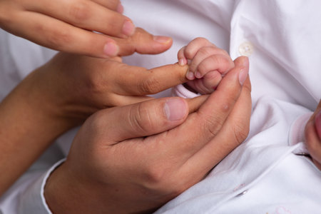 Close up of newborn baby hand and mother's hand. Family concept.の写真素材