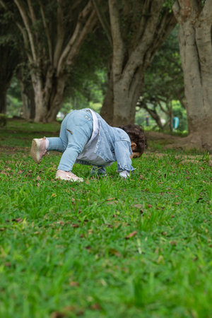 Young woman doing push ups on the grass in the parkの写真素材