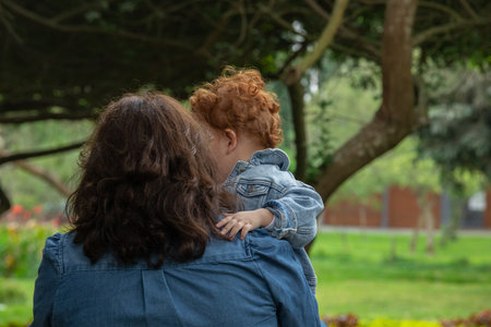 Mother and son looking at each other in the park on a sunny dayの写真素材
