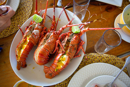 Lobster with lime and sauce on a wooden table in a restaurant