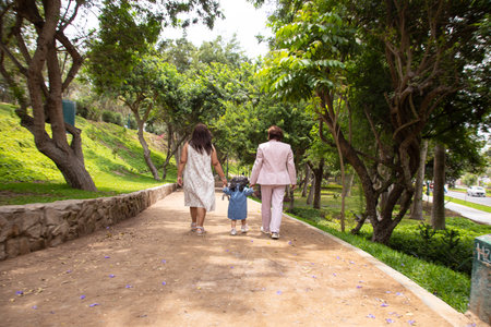 Asian women walking in the park with a dog in their hands.の写真素材