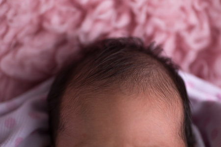 Newborn baby lying on pink blanket, closeup. Space for textの写真素材