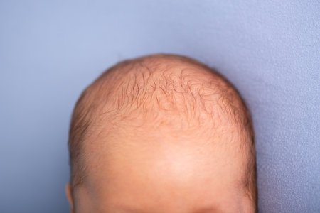 Close-up of a newborn baby's hair on a blue backgroundの写真素材
