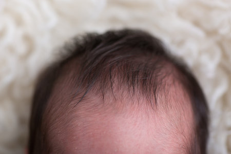 Newborn baby boy with hair on his head, close-upの写真素材