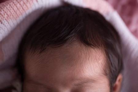 Cute newborn baby sleeping on a pink blanket. Shallow depth of fieldの写真素材