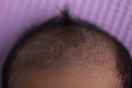 Close-up of a newborn baby's hair on a purple backgroundの写真素材