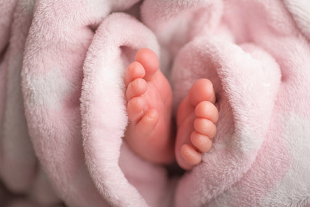 Newborn baby feet on pink towel, closeup. Baby care conceptの写真素材