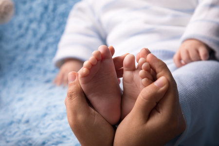 Baby feet in mother's hands, close-up. Newborn concept
