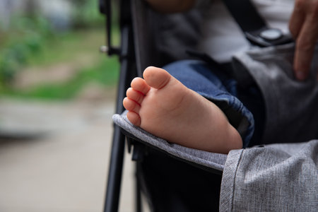 Close-up of a baby's foot in a stroller.の写真素材