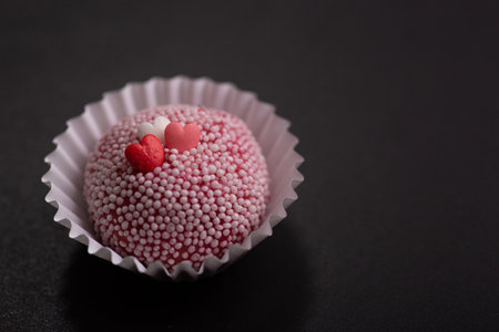 Brazilian traditional brigadeiro Valentine's Day cake on a black background. Selective focus.