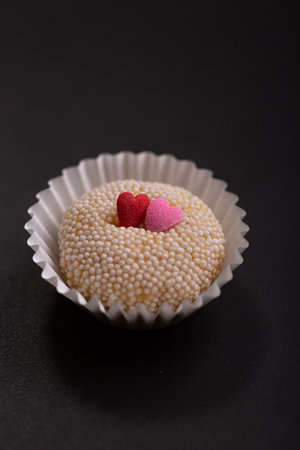 Brigadeiros Brasil Brasilianm dessert sweet food gourmet with heart shaped sprinkles on a black backgroundの写真素材