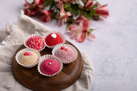Assorted chocolate truffles on wooden plate. Selective focusの写真素材