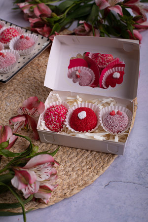 Wedding cake in a box with flowers. Selective focus.の写真素材
