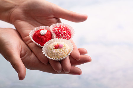 Brigadeiro traditional Brazilian Brasil sweet dessert Hand holding chocolate candies on light background, closeup. Delicious dessertの写真素材