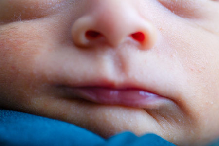 Close up of a newborn baby's face. Shallow depth of field.