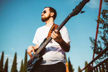 Outdoor photo session with a bass player and his instrumentsの写真素材