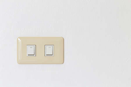 Lighting switch on white concrete background with copy spaceの写真素材