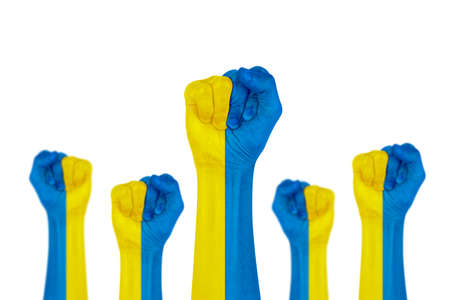 Hand of a woman painting the ukraine flag. Concept of ending the war in Ukraine.