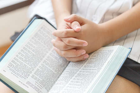 Woman praying over a bible. Pray and bible concept.