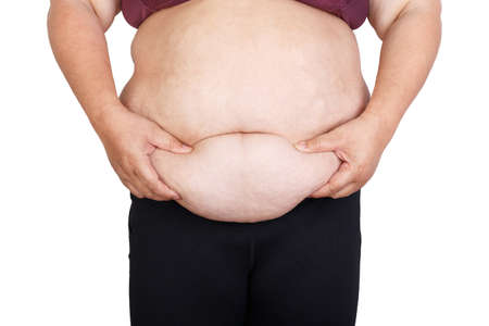 Woman with excessive belly fat against isolated on white backgroundの写真素材