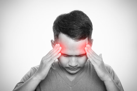 Man with strong headache. Isolated on white background. Healthcare and health problem conceptの写真素材