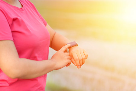 Woman hands setting smart watch. Technology and people conceptの写真素材