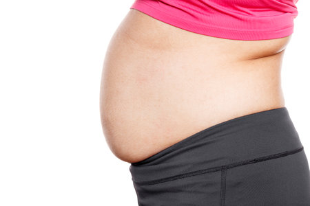 Woman with excessive belly fat against isolated on white backgroundの写真素材