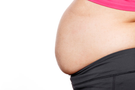 Woman with excessive belly fat against isolated on white backgroundの写真素材