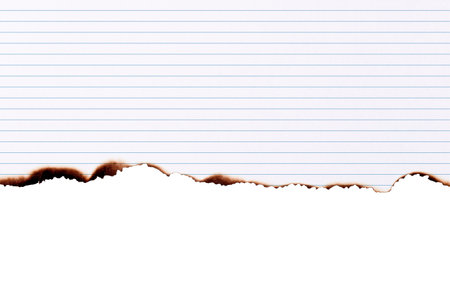 Notebook paper burned half isolated on white background with clipping pathの写真素材