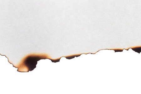 Paper with burnt edges on a white backgroundの写真素材