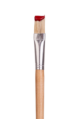 Flat wooden paintbrush with red paint on bristles, isolated on white backgroun, clipping pathの写真素材