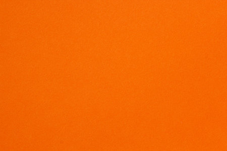 Bright orange paper texture background with subtle grain, perfect for creative designs, crafts, and modern visual projects.の写真素材