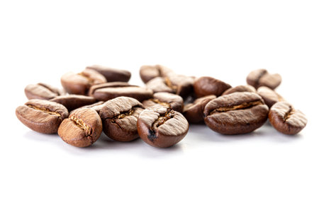 A pile of roasted coffee beans with rich texture and aroma on white backgroundの写真素材