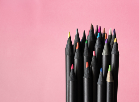 group of multicoloured pencils black wooden i on pink pastel background, unity in differenty conceptの写真素材