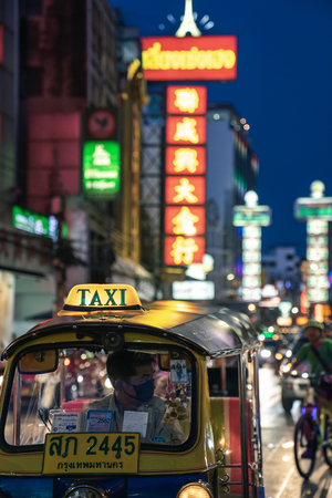 CHINATOWN, BANGKOK, THAILAND - 05/05/18: Tuk tuk taxi parked in street market in the main street of Chinatown, Yaowarat road.のeditorial素材