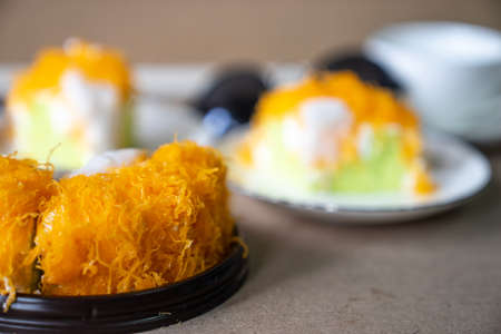 close up selective focus piece of  Gold Egg Yolk Thread Cake , or  'Cake Foi Tong Thai pandan cake ...