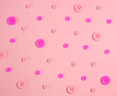 flat lay top view pink buttons pattern isolated on pastel soft pink backgroundの写真素材