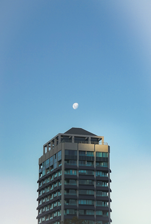 The moon was shined on top of a building in the afternoon, day time on blue sky in Sydney, Australia.のeditorial素材