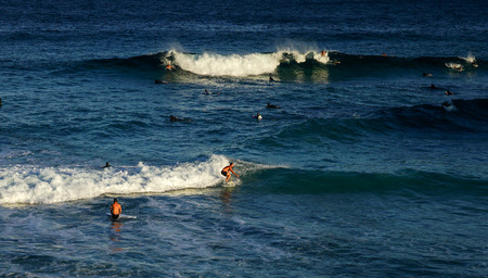 Australian young man and lady surfing at Tamarama beach in Sydney, as Surfing sport is one of popular outdoor extreme sport of Australia.のeditorial素材