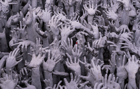 statue of grey hands art in Chiang Rai temple, Thailandのeditorial素材