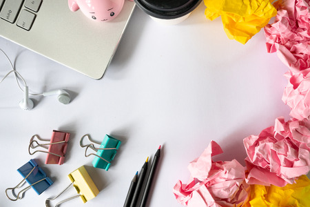 creative colourful office accessories and crumbled paper ball on white background. creative and...