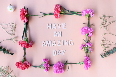 Minimal flat lay  you are amazing inspiration wooden word with fresh flowers frame
