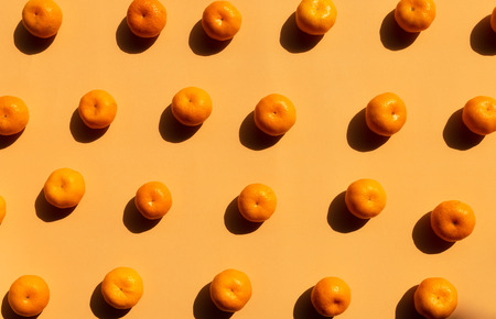 top view pattern Background of whole oranges with strong shadow on orange backgroundの写真素材